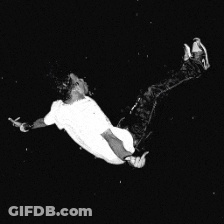 A Man In A White Shirt Is Flying Through The Air GIF