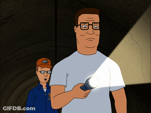 A Man In A White Shirt Is Holding A Flashlight Next To A Man In A Blue Jacket GIF