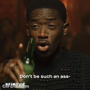 A Man In A White Shirt Is Holding A Glass And Says Dickhead GIF