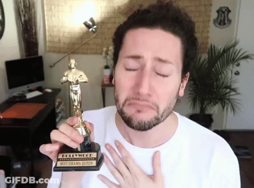 A Man In A White Shirt Is Holding A Hollywood Best Drama Queen Award GIF