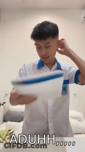 A Man In A White Shirt Is Holding A Piece Of Paper With The Word Aduh Written On The Bottom GIF