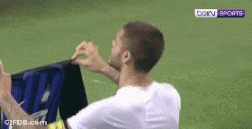 A Man In A White Shirt Is Holding A Sign That Says Bein Sports . GIF