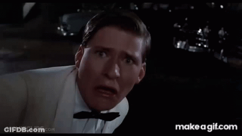 A Man In A White Shirt Is Holding His Fist Up And Says Why You Lucky Son Of GIF