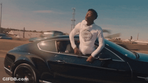 A Man In A White Shirt Is Leaning Out Of The Window Of A Black Car GIF