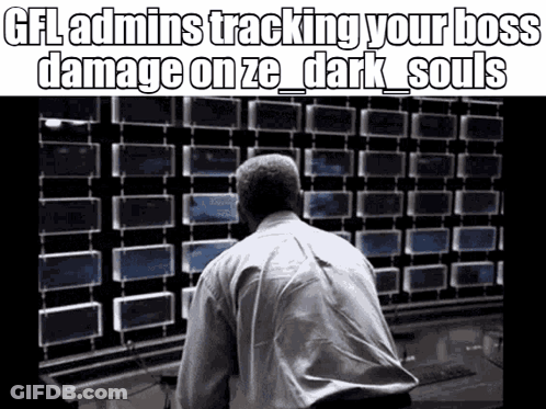 A Man In A White Shirt Is Looking At A Wall Of Monitors . GIF