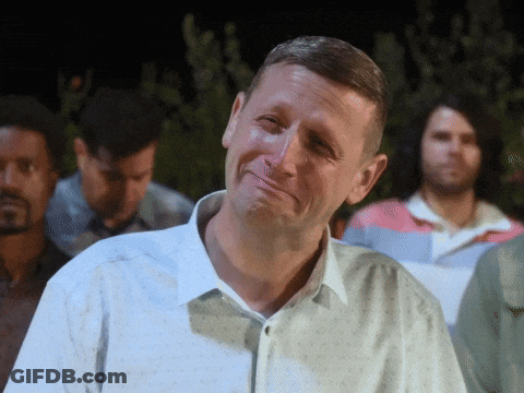 A Man In A White Shirt Is Making A Face GIF