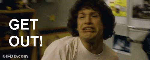 A Man In A White Shirt Is Making A Face And Says Get Out GIF