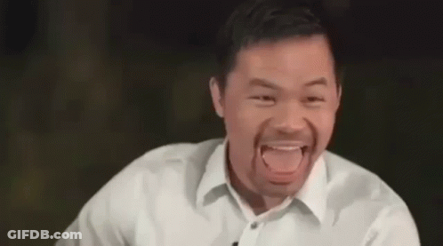A Man In A White Shirt Is Making A Funny Face . GIF