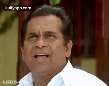 A Man In A White Shirt Is Making A Funny Face And Making A Funny Face . GIF