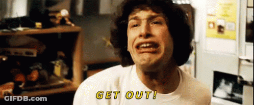 A Man In A White Shirt Is Making A Funny Face And Says Get Out . GIF