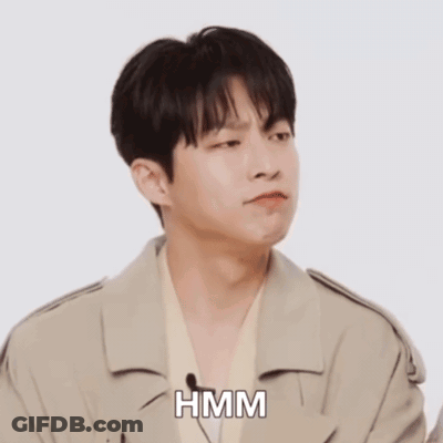 A Man In A White Shirt Is Making A Funny Face And The Word Hmm Is On The Bottom GIF