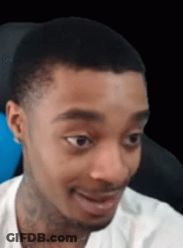 A Man In A White Shirt Is Making A Funny Face . GIF