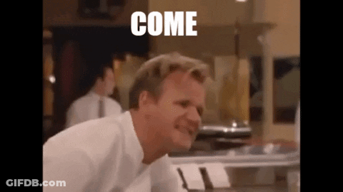 A Man In A White Shirt Is Making A Funny Face In A Kitchen With The Word Come Written On The Screen . GIF