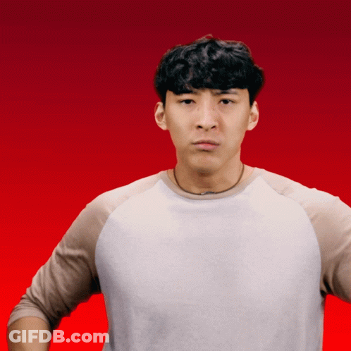 A Man In A White Shirt Is Making A Funny Face With His Hands On His Hips GIF