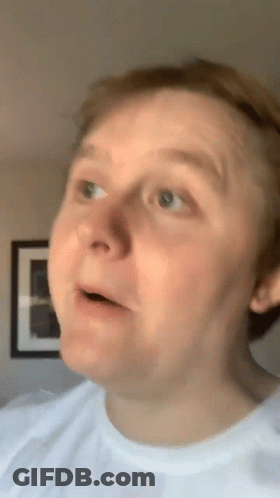A Man In A White Shirt Is Making A Funny Face With His Mouth Open GIF