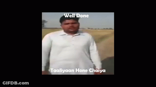 A Man In A White Shirt Is Making A Funny Face With The Words Well Done Taaliyaan Hone Chaiya Below Him GIF