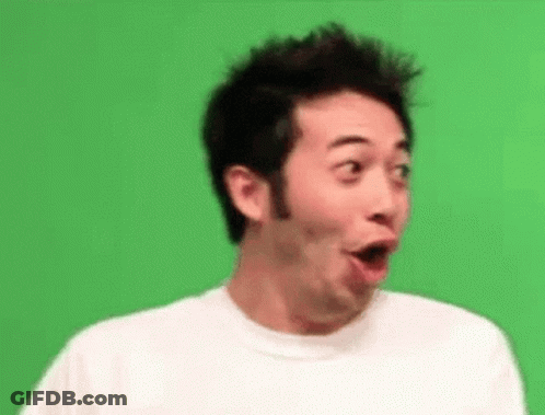 A Man In A White Shirt Is Making A Surprised Face . GIF