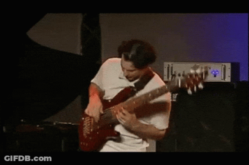 A Man In A White Shirt Is Playing A Guitar In Front Of A Yamaha Amplifier GIF