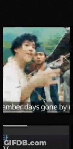 A Man In A White Shirt Is Pointing At Something In A Video That Says ' Amber Days Gone By ' GIF