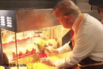 A Man In A White Shirt Is Preparing French Fries In A Display Case GIF