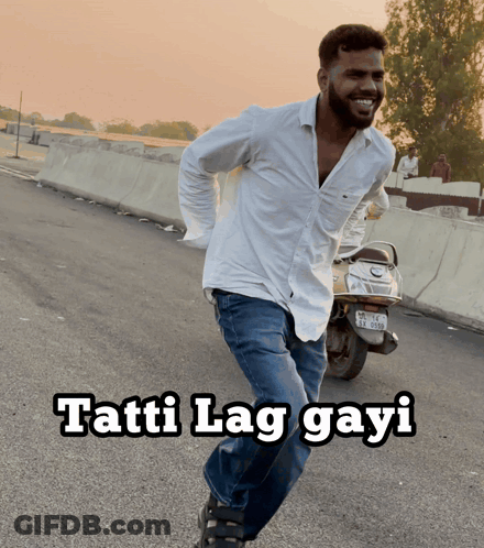 A Man In A White Shirt Is Running Down The Road With The Words Tatti Lag Gayi Written Below Him GIF