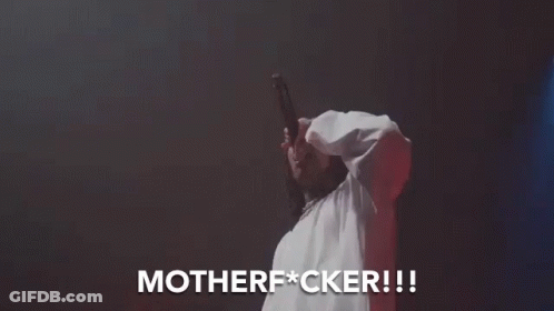 A Man In A White Shirt Is Singing Into A Microphone And The Words Motherfucker Are Above Him GIF