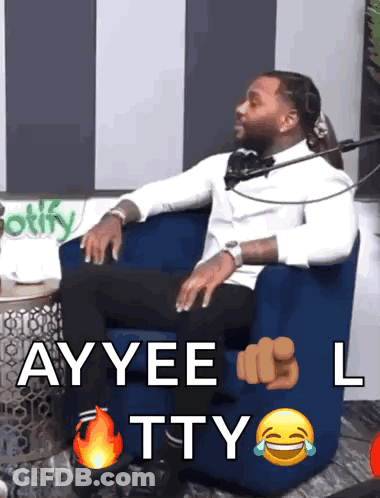 A Man In A White Shirt Is Sitting In A Blue Chair With The Words Ayyee L Tty Written On It GIF