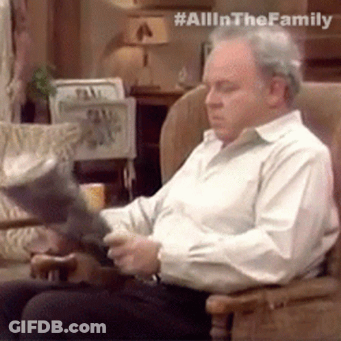 Man In White Shirt Reading Book In Rocking Chair GIF
