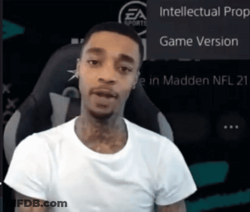 A Man In A White Shirt Is Sitting In Front Of A Screen That Says Intellectual Prop Game Version GIF
