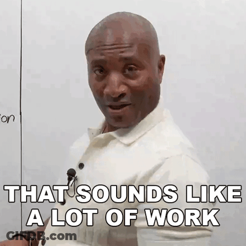 A Man In A White Shirt Is Sitting In Front Of A White Board . GIF