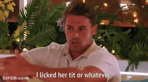 A Man In A White Shirt Is Sitting In Front Of A Window And Talking To Someone . GIF