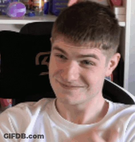 A Man In A White Shirt Is Smiling And Clapping His Hands . GIF