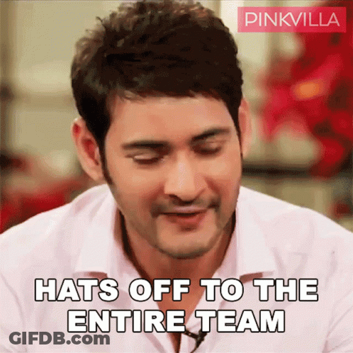 A Man In A White Shirt Is Smiling And Says Hats Off To The Entire Team GIF