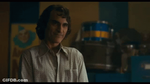 Man Smiling In White Shirt In Front Of Drum GIF