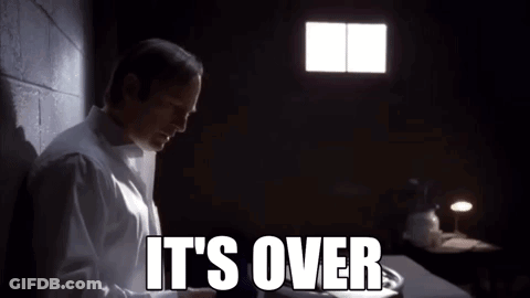A Man In A White Shirt Is Standing In A Dark Room With The Words It 'S Over Written On The Screen . GIF