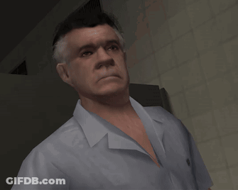 A Man In A White Shirt Is Standing In A Room GIF