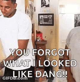A Man In A White Shirt Is Standing In A Room And Saying `` You Forgot What I Looked Like Dang !! '' GIF