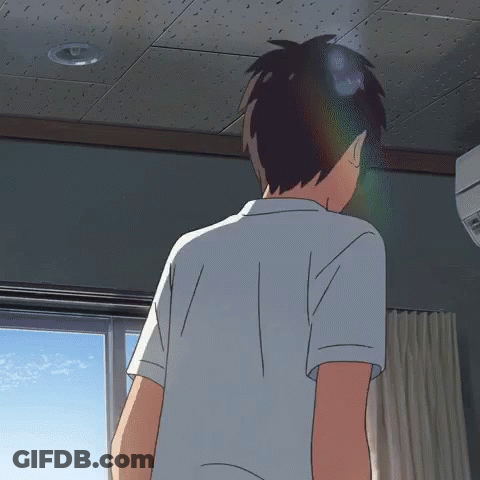 A Man In A White Shirt Is Standing In A Room GIF