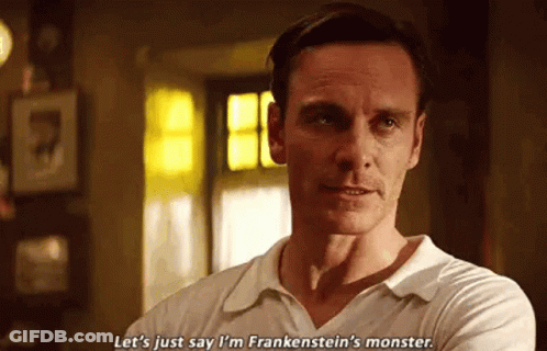 A Man In A White Shirt Is Standing In A Room With His Arms Crossed . GIF