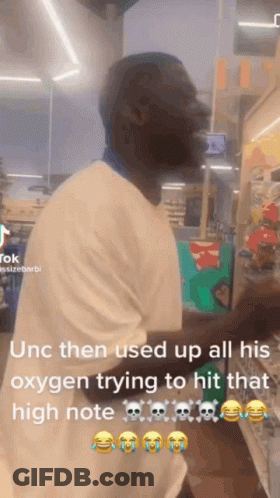 A Man In A White Shirt Is Standing In A Store And Using Oxygen To Try To Hit That High Note . GIF
