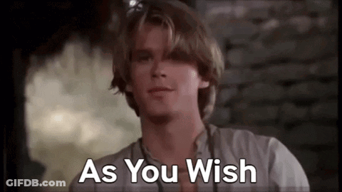A Man In A White Shirt Is Standing In Front Of A Brick Wall And Says `` As You Wish '' . GIF
