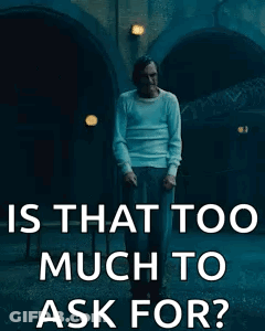 Man In White Shirt In Front Of Building GIF