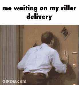 A Man In A White Shirt Is Standing In Front Of A Door Waiting For A Delivery . GIF