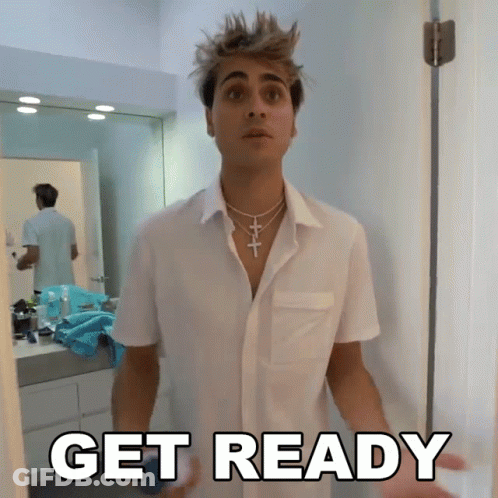 A Man In A White Shirt Is Standing In Front Of A Door With The Word Get Ready Written On It GIF