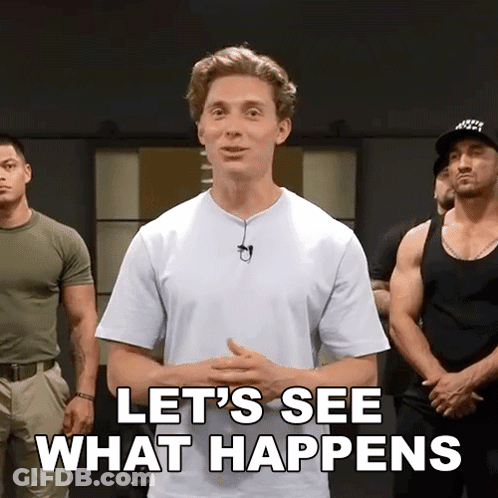 A Man In A White Shirt Is Standing In Front Of A Group Of Men And Says Let 'S See What Happens GIF