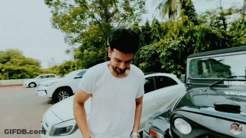 A Man In A White Shirt Is Standing In Front Of A Jeep That Says Bhok GIF