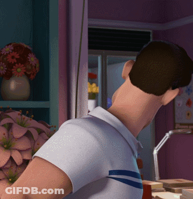 A Man In A White Shirt Is Standing In Front Of A Shelf With Flowers GIF