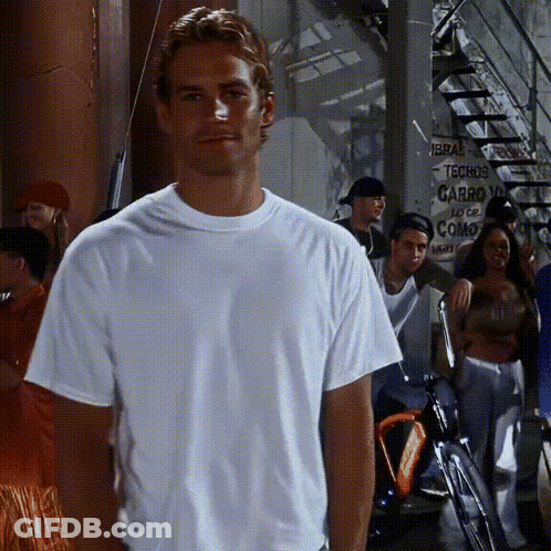 A Man In A White Shirt Is Standing In Front Of A Sign That Says Techos Carro GIF