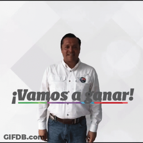 A Man In A White Shirt Is Standing In Front Of A Sign That Says " Vamos A Ganar " GIF
