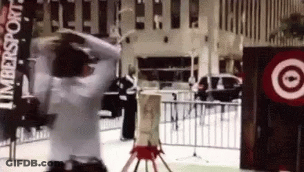 A Man In A White Shirt Is Standing In Front Of A Target Sign GIF